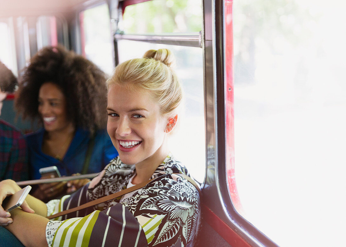 Portrait smiling blonde woman riding bus