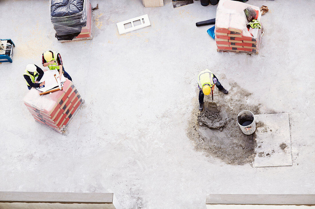 Construction workers laying concrete