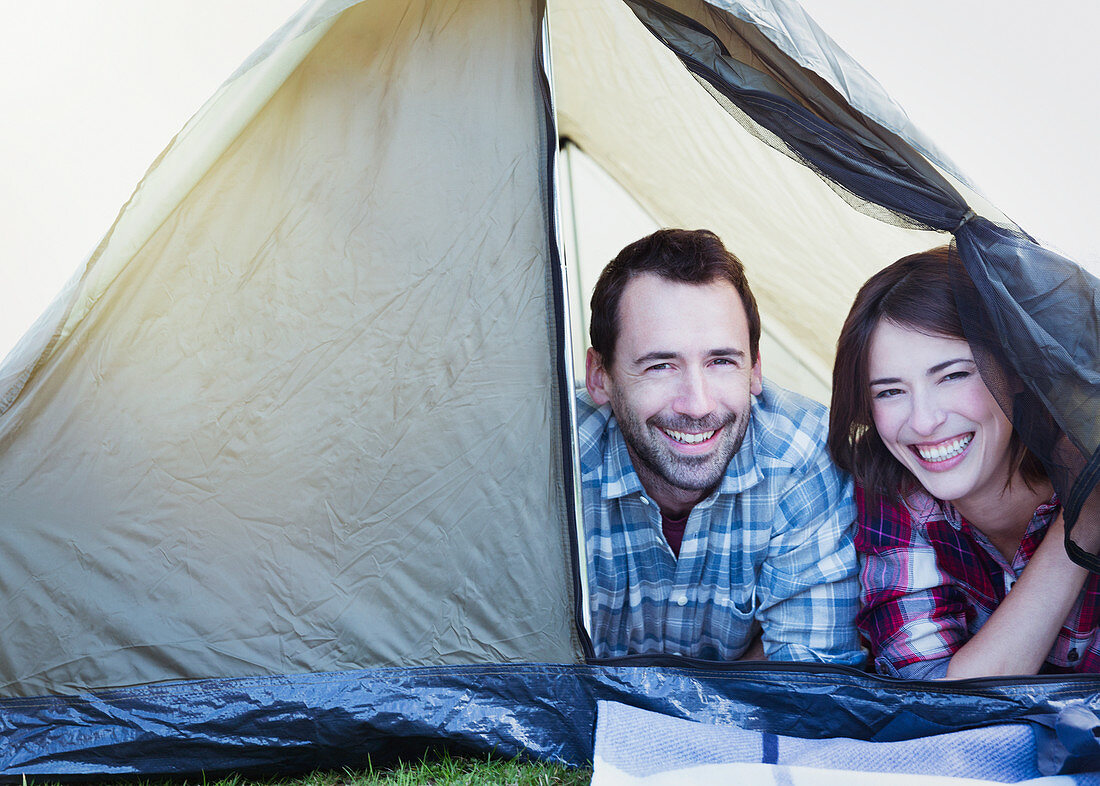 Portrait smiling couple in tent