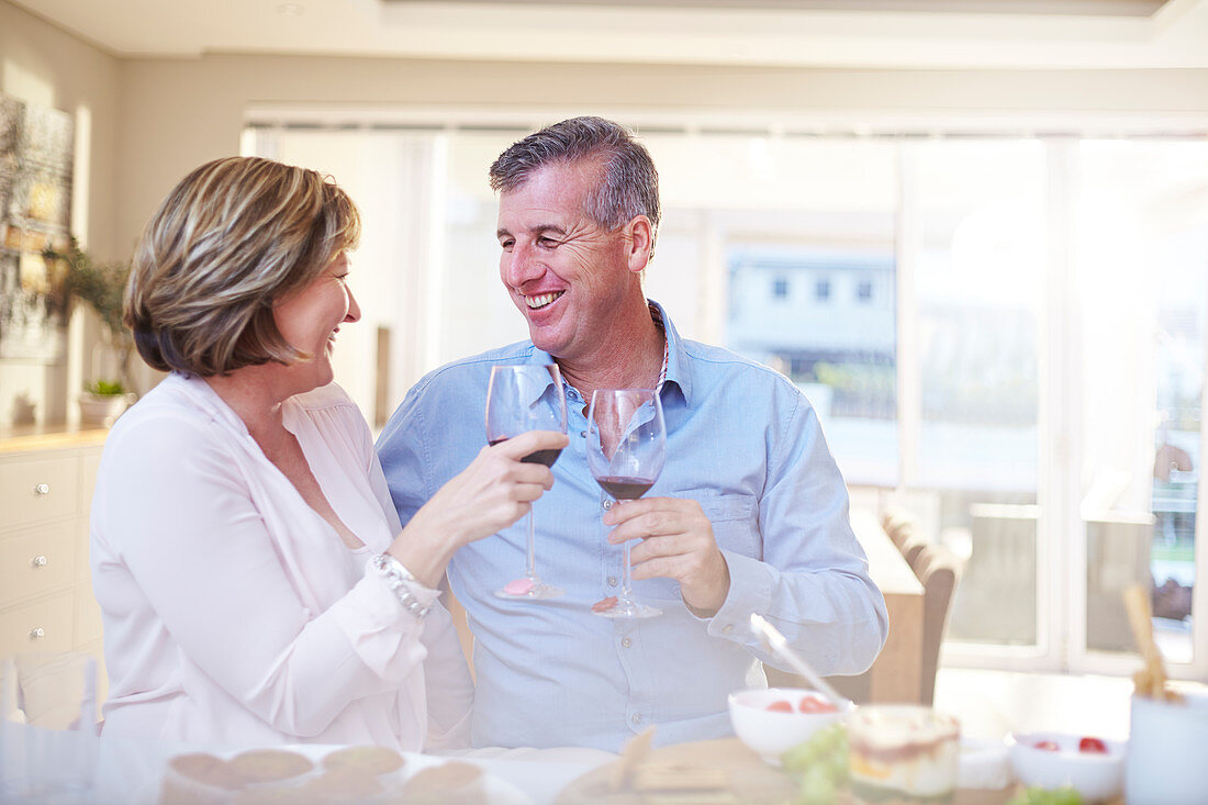 Couple toasting red wine glasses
