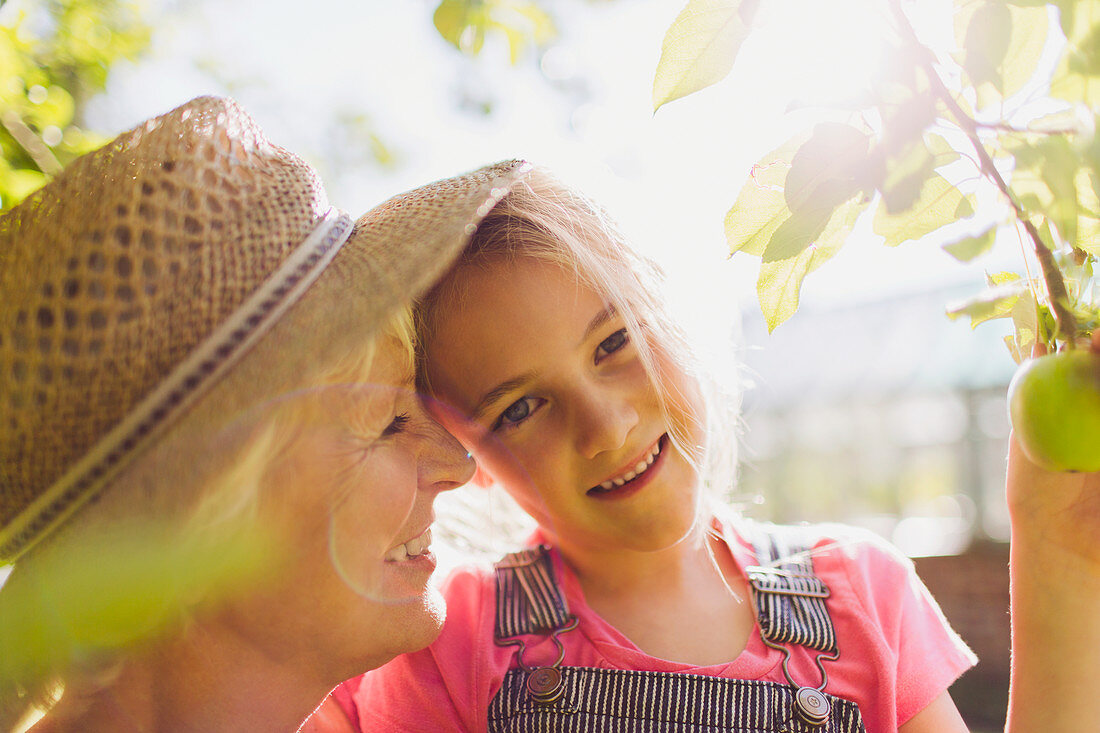 Granddaughter with grandmother in garden