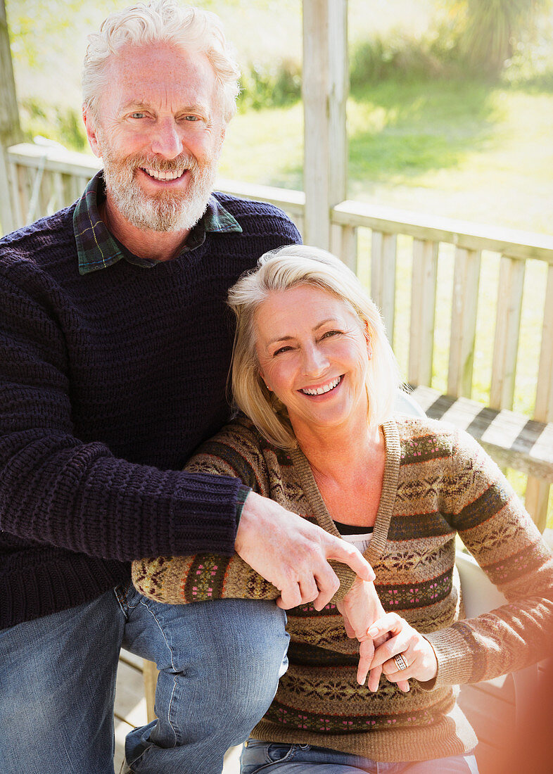 Portrait smiling senior couple on porch