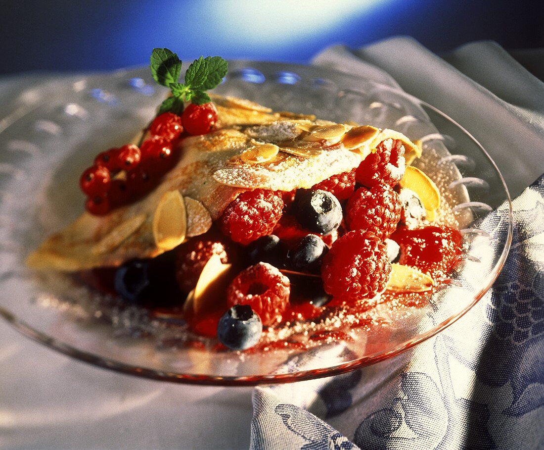 Crepe with mixed berries and flaked almonds