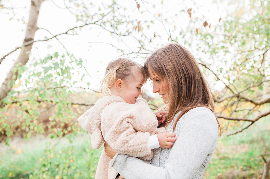 Mother holding toddler daughter