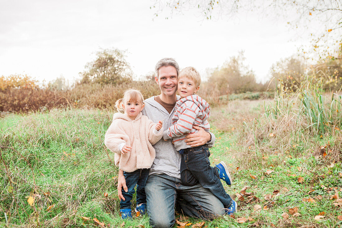 Father and toddler children in park