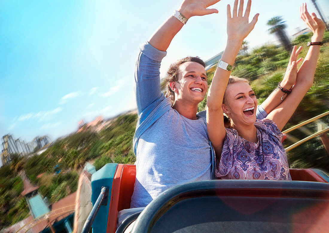 Couple riding amusement park ride