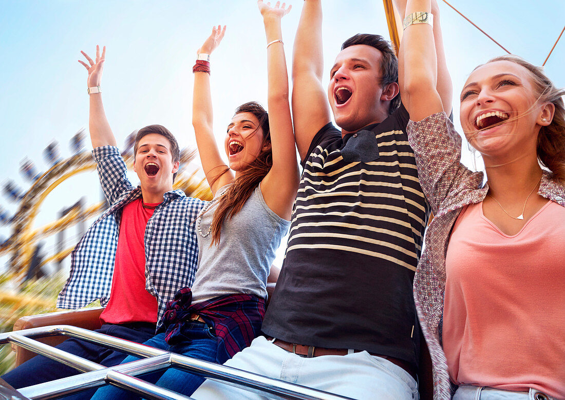 Cheering friends on amusement park ride