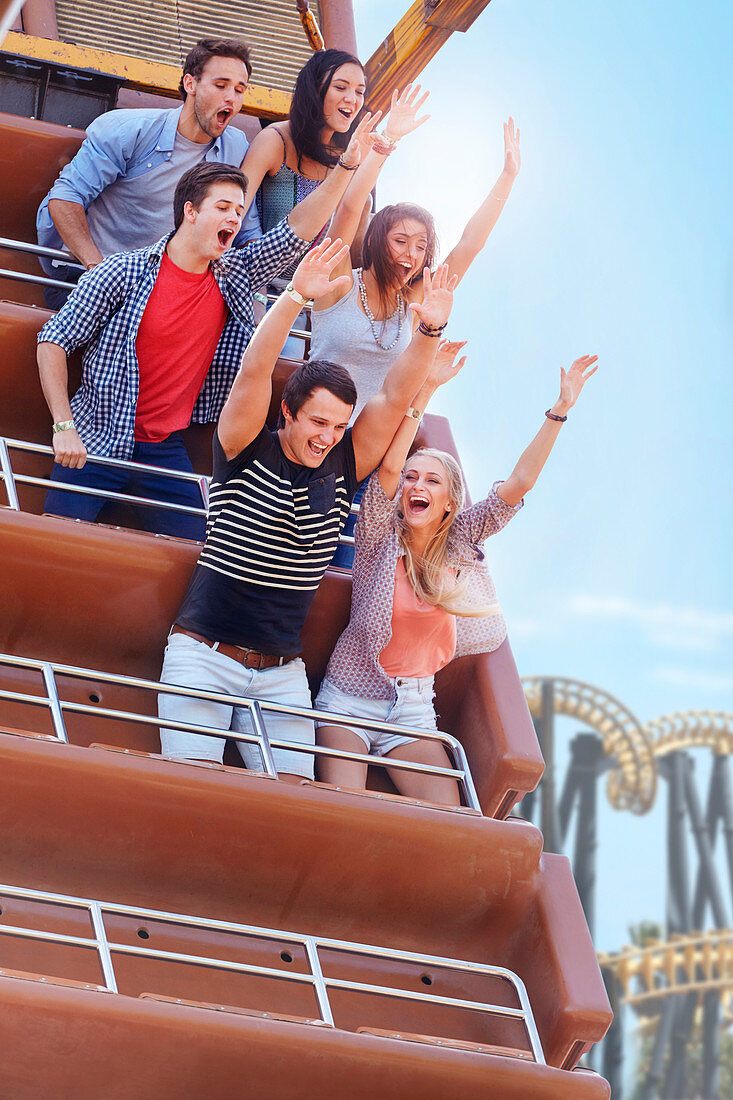 Friends cheering on amusement park ride