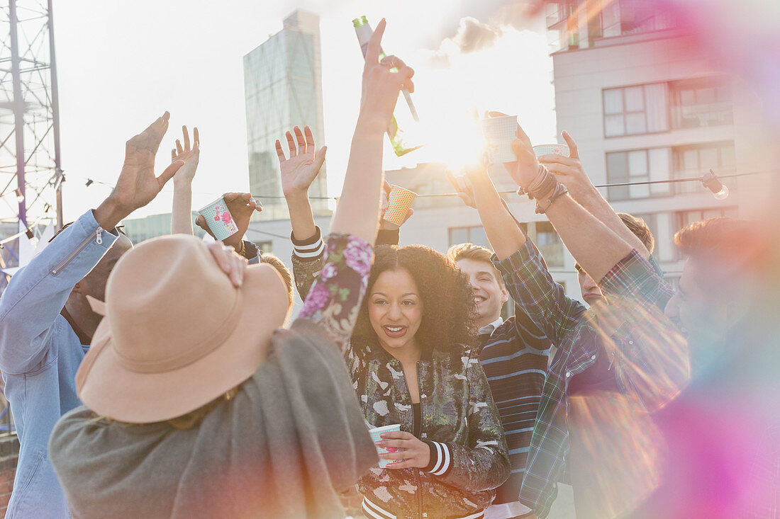 Young adults dancing at rooftop party