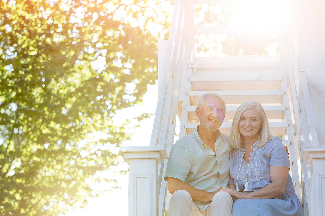 Senior couple sitting on summer stairs