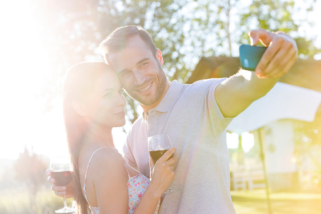 Couple taking selfie in backyard