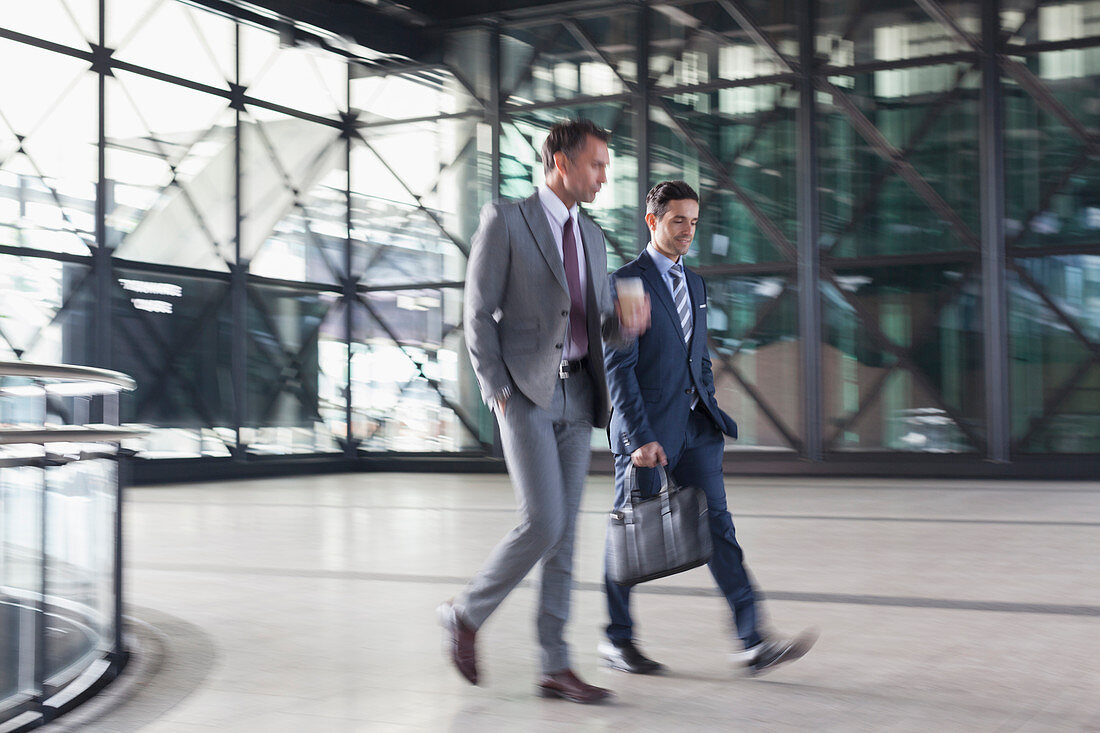 Businessmen walking in modern lobby