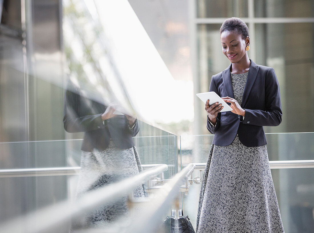 Corporate businesswoman using tablet
