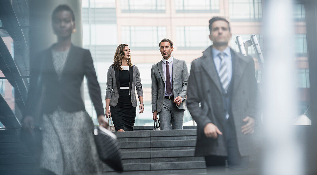 Business people descending stairs