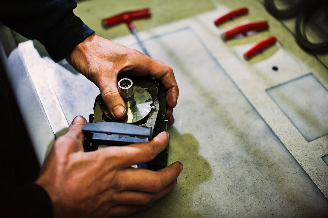 Worker assembling parts in steel factory