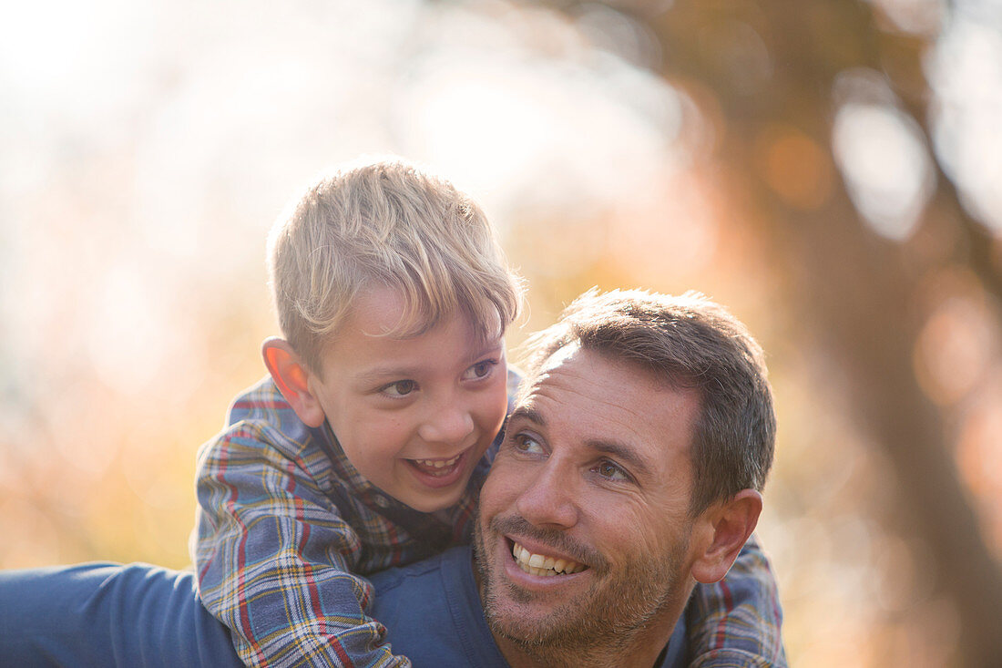 Affectionate father and son piggybacking