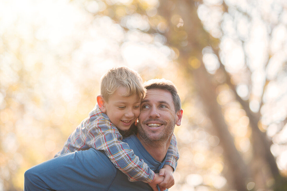 Affectionate father and son piggybacking