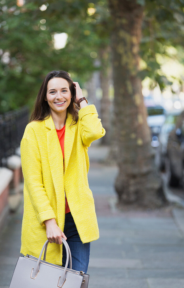 Portrait smiling woman on sidewalk