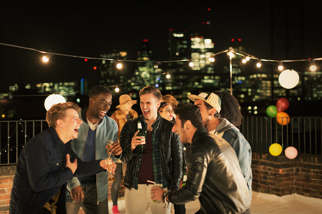 Young men drinking and laughing