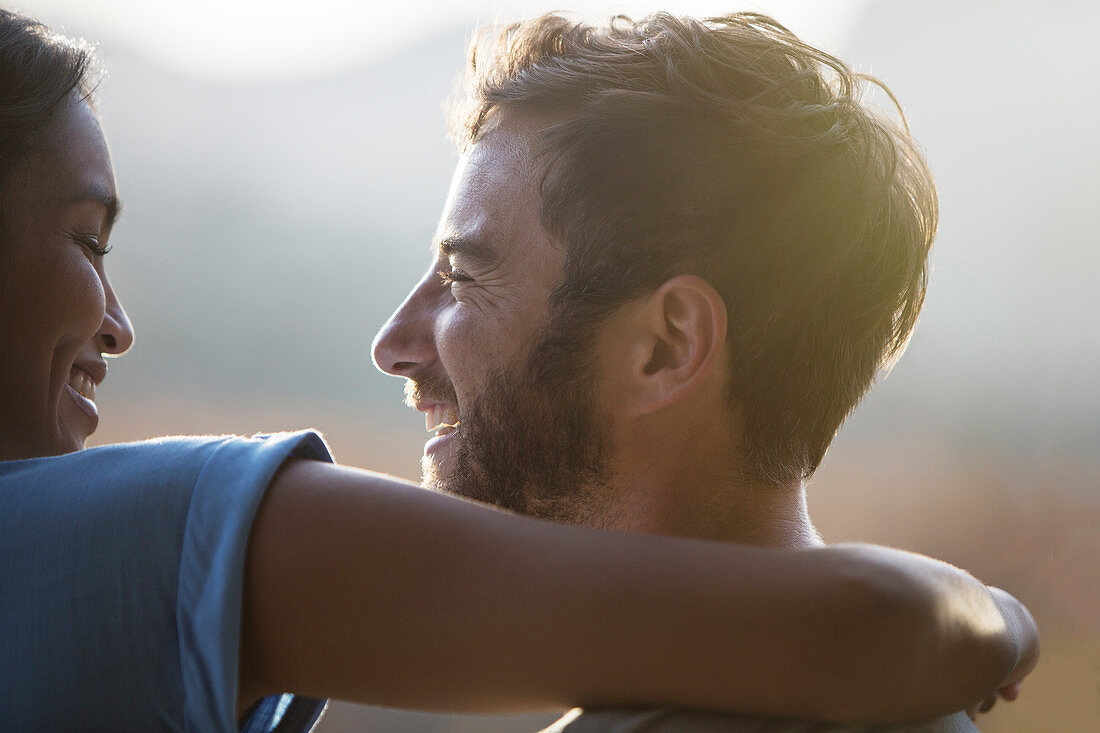 Close up smiling couple hugging