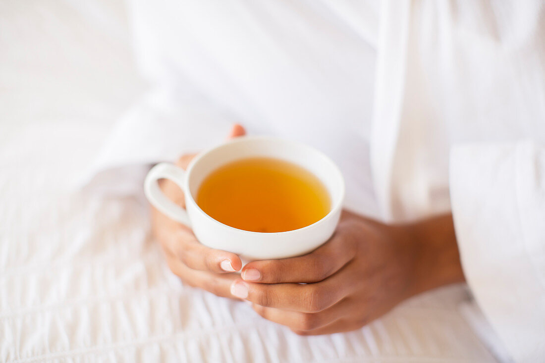 Close up woman holding cup of tea