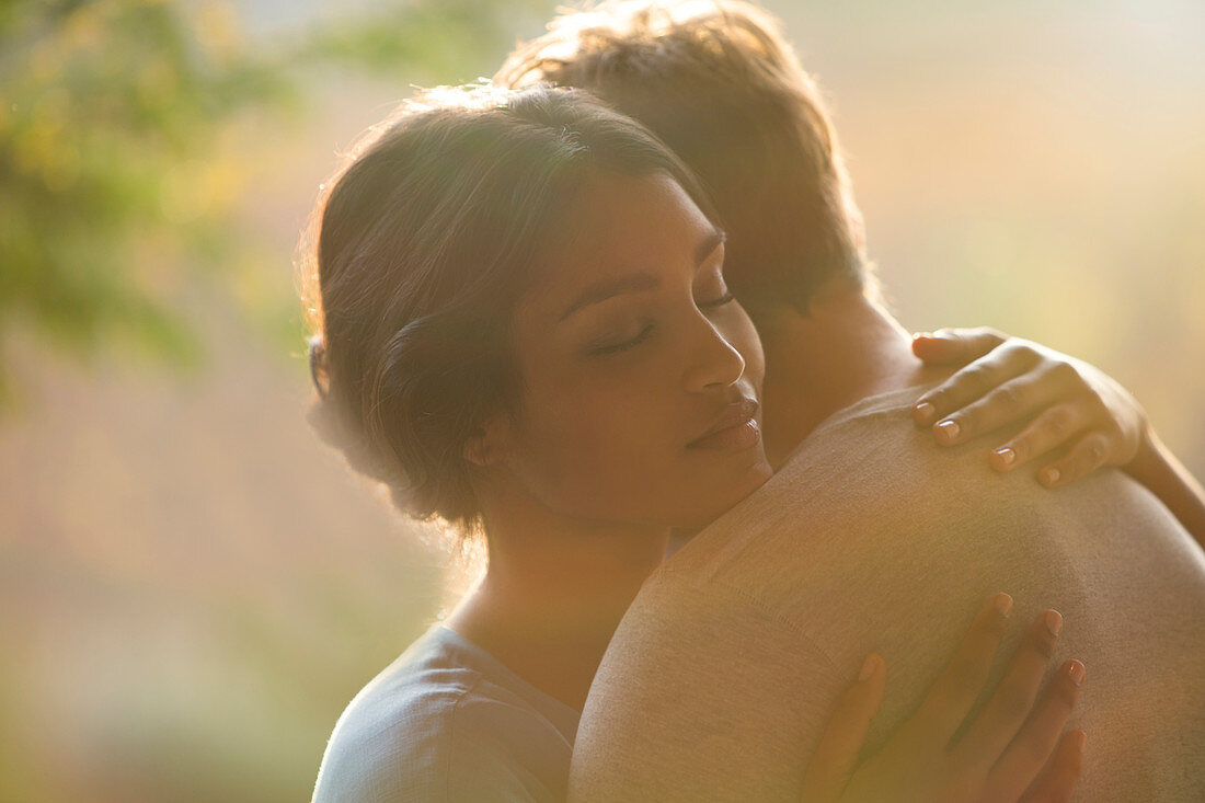 Close up serene couple hugging