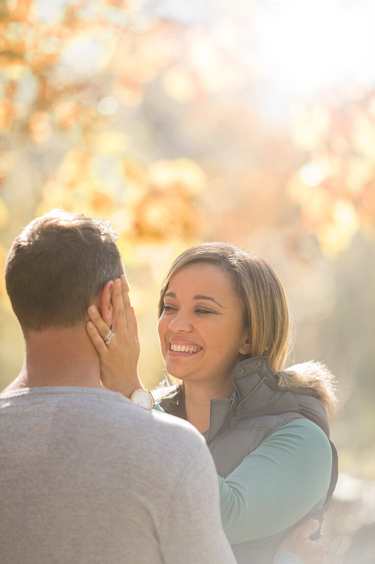 Affectionate couple hugging face to face