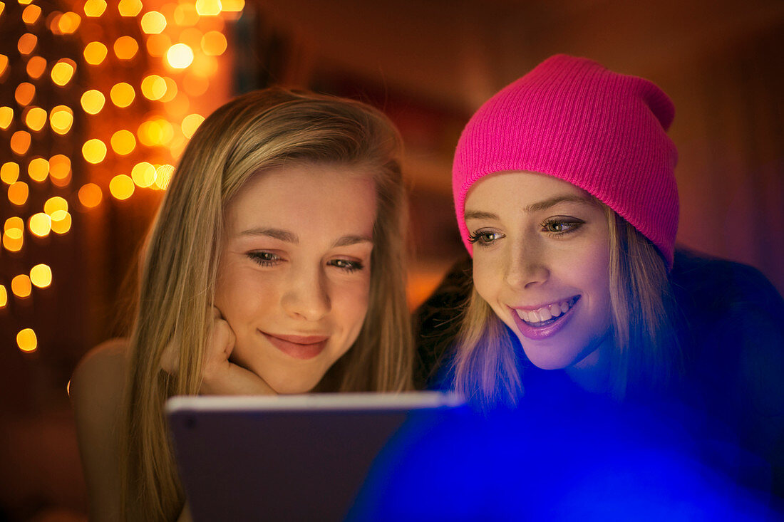 Teenage girls using digital tablet
