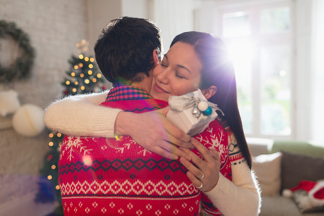 Couple hugging at Christmas