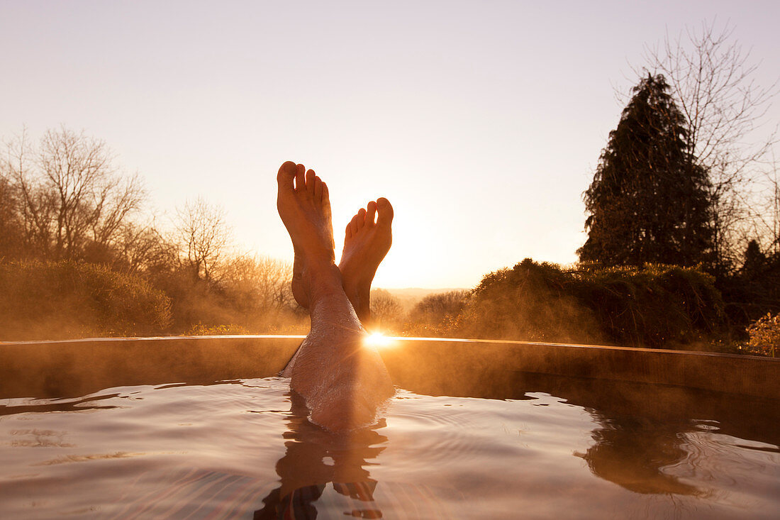 Man's feet raised out of pool