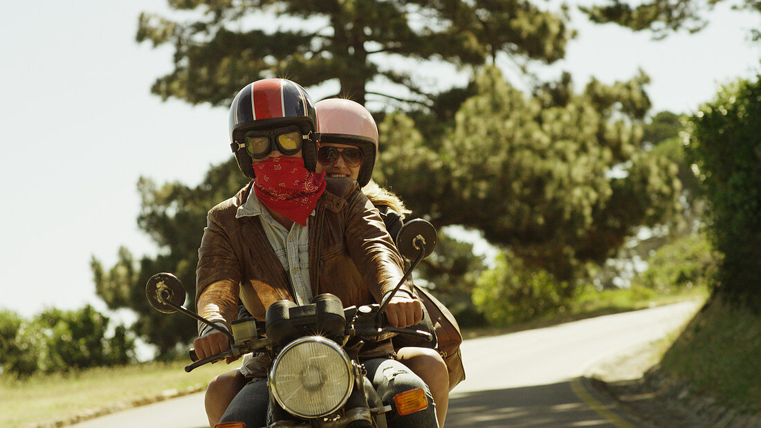Young couple riding motorcycle