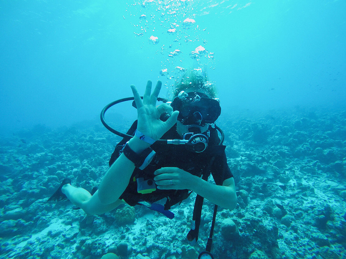 Scuba diver gesturing okay underwater