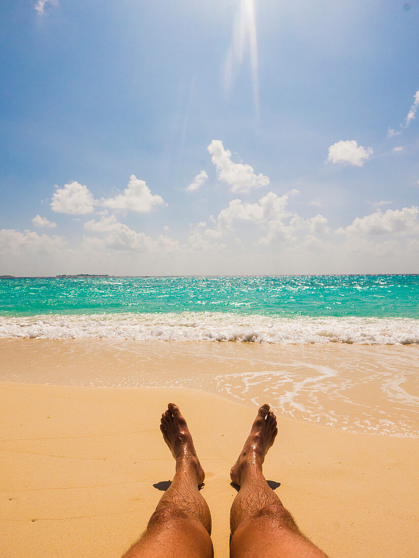 Man sunbathing on sunny tropical beach