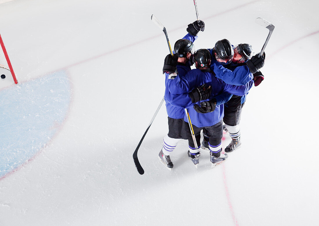 Hockey team in blue uniforms cheering