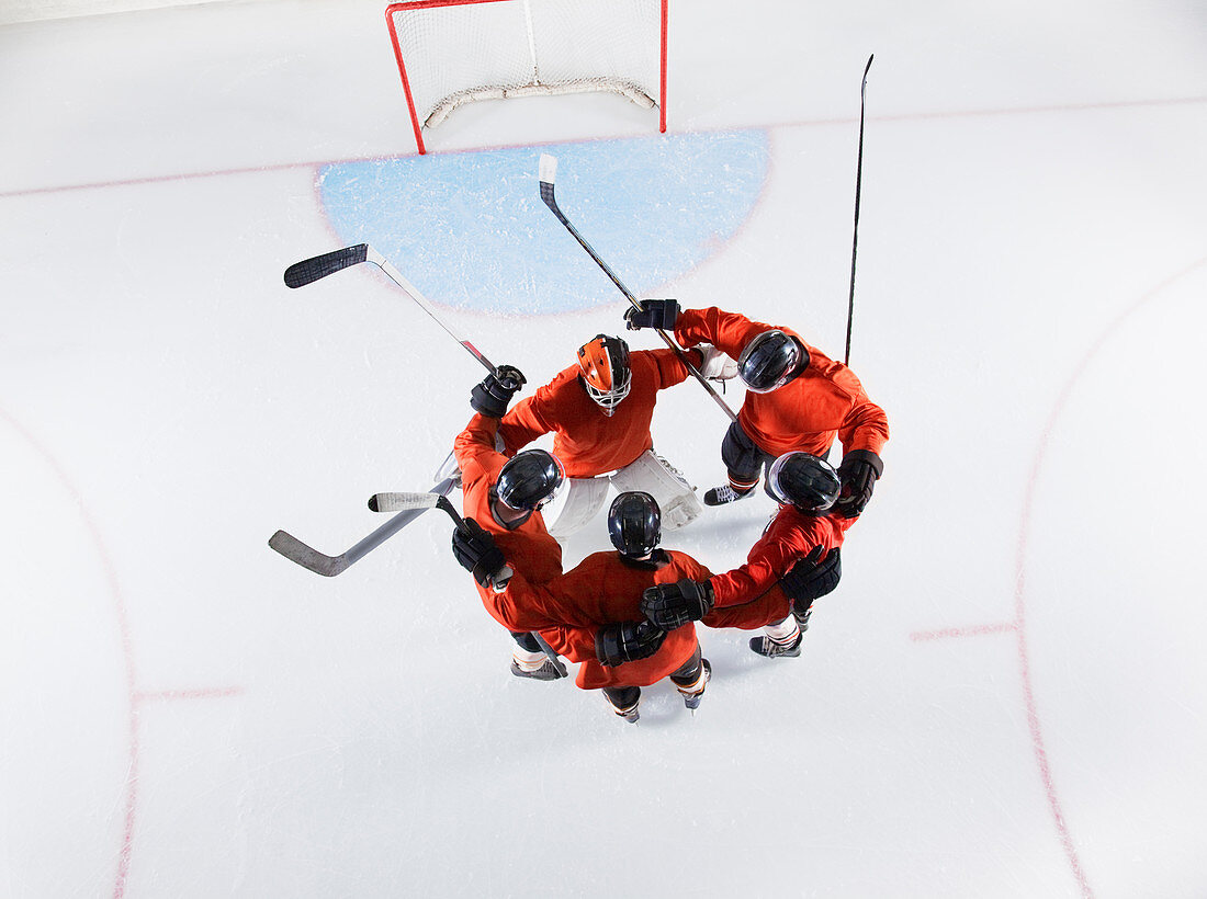 Hockey team in red uniforms huddling