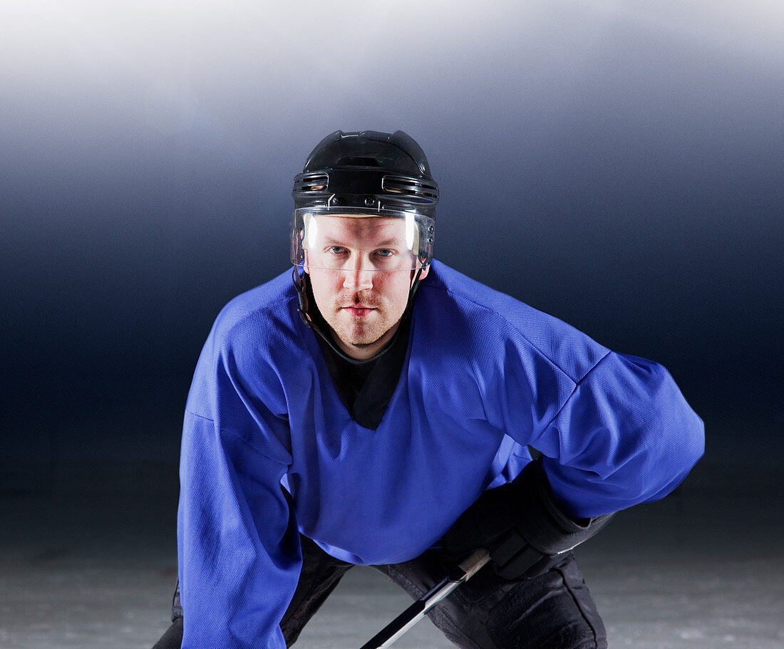 Hockey player in blue uniform on ice
