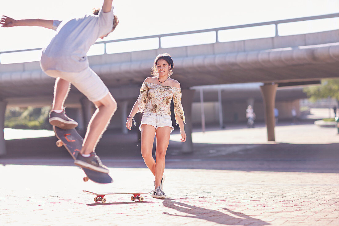 Boy and girl skateboarding