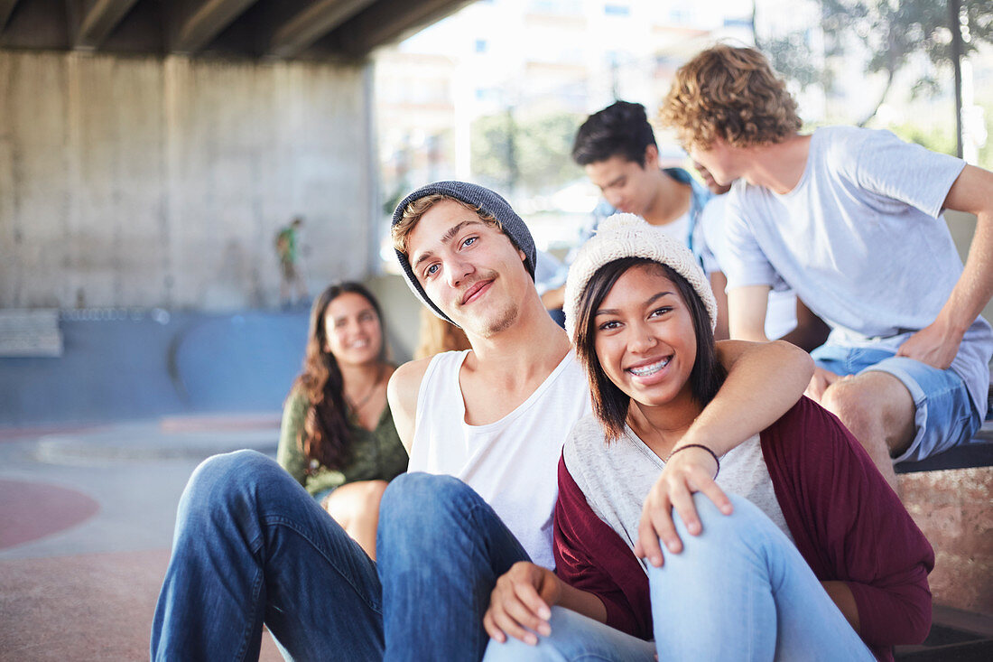 Teenage couple hanging out with friends