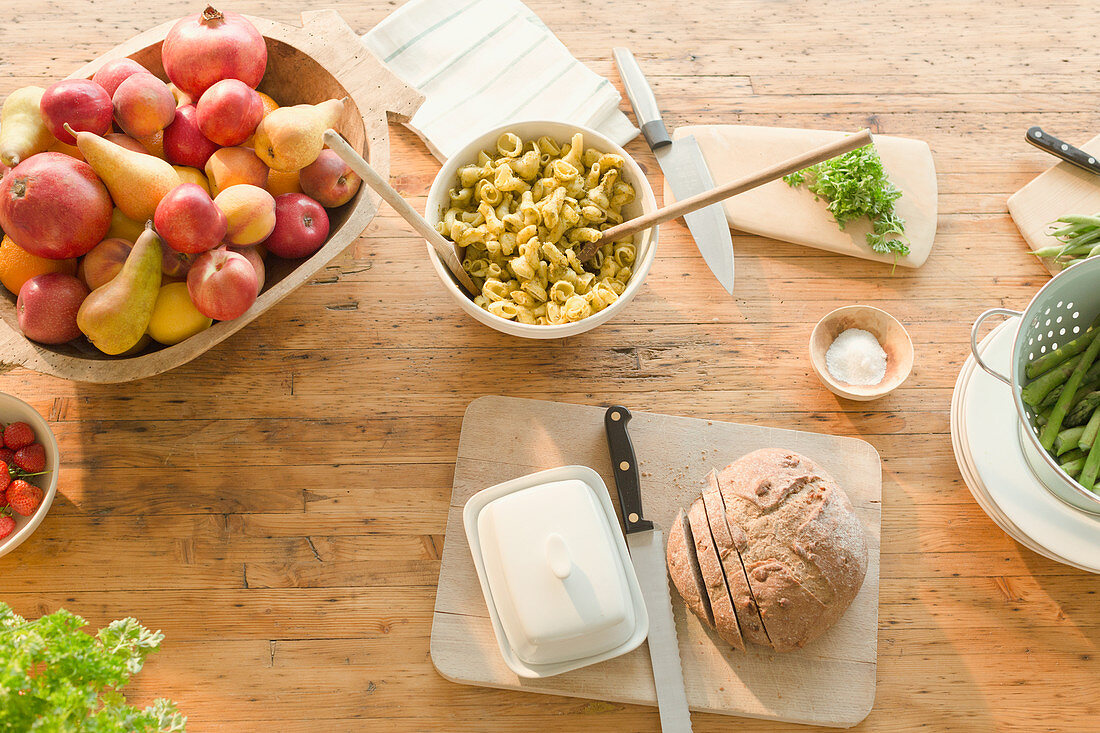 Pasta, fruit and bread on dining table