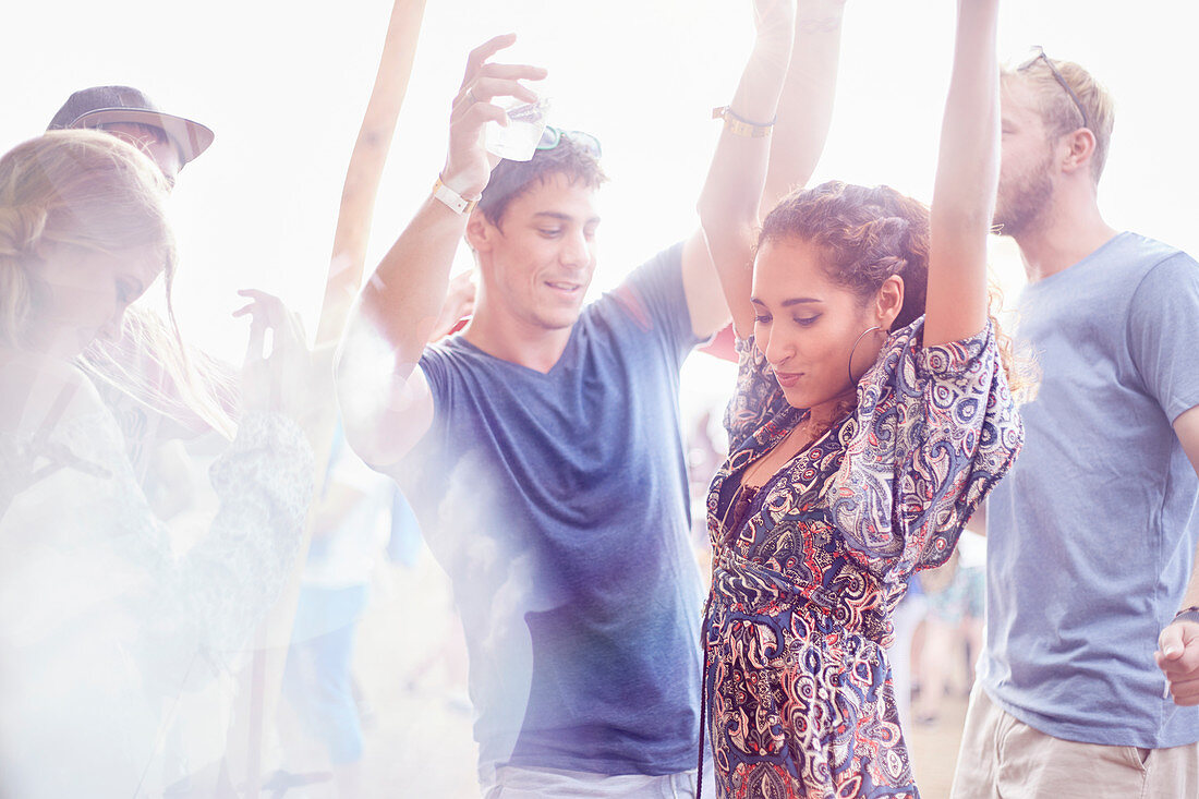 Young couple dancing at music festival