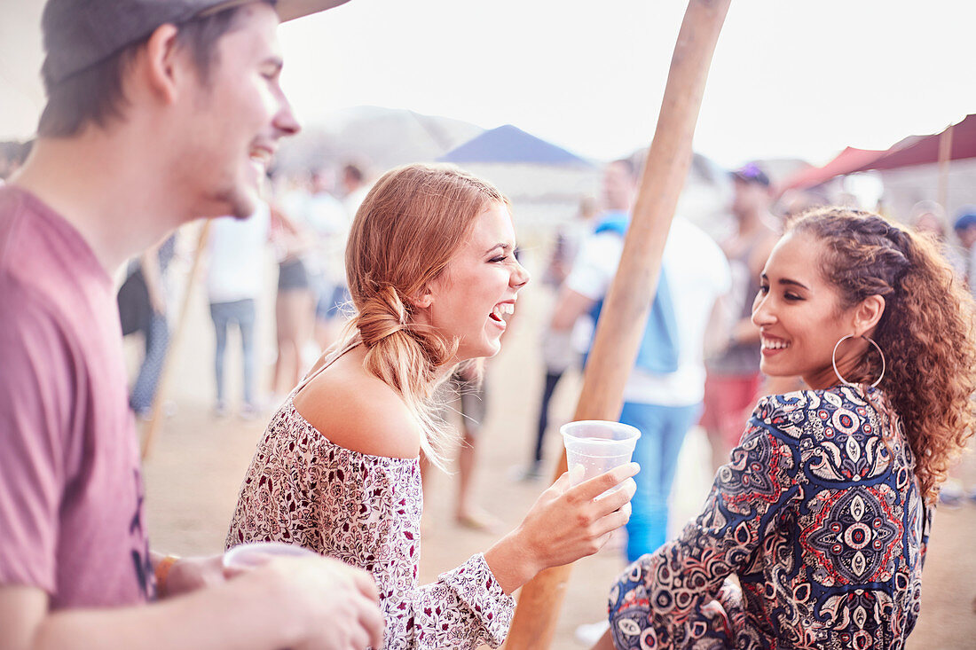 Friends drinking at music festival