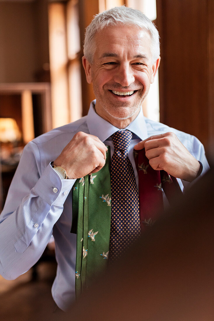 Businessman trying on ties
