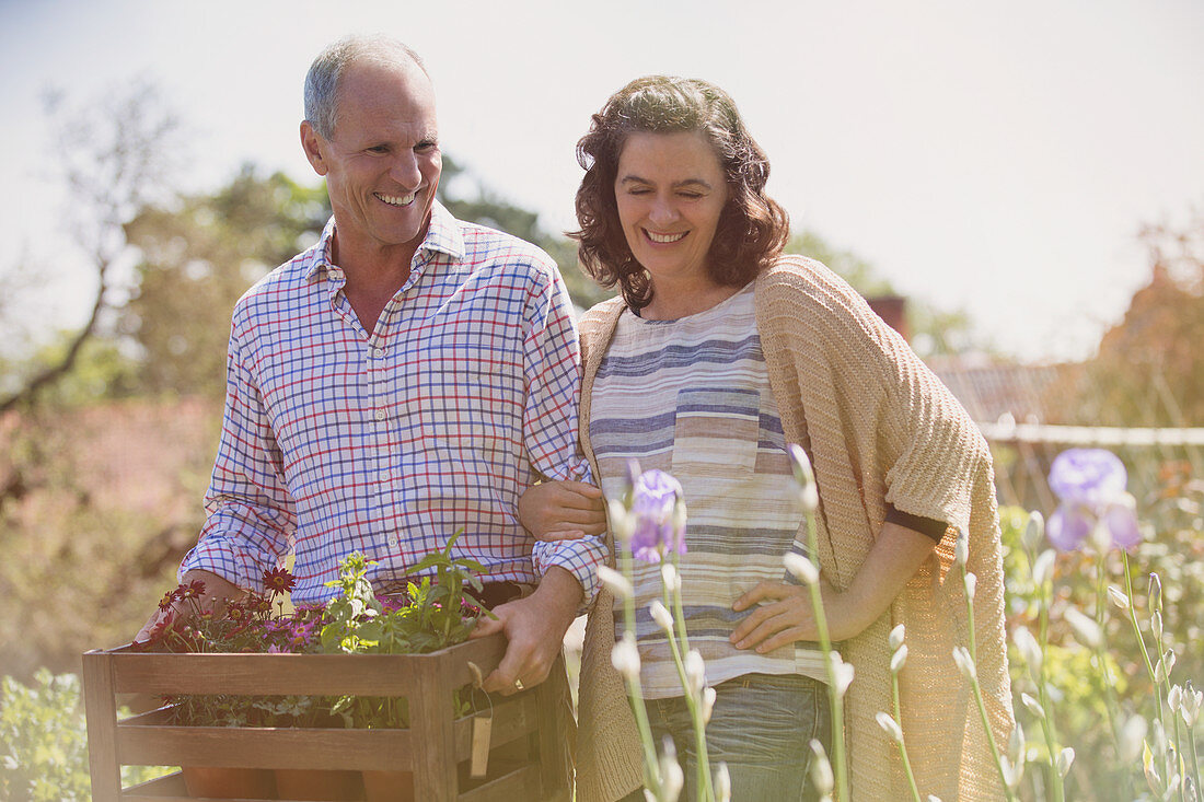 Smiling couple shopping for flowers