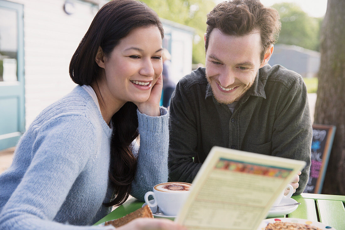 Smiling couple reading menu