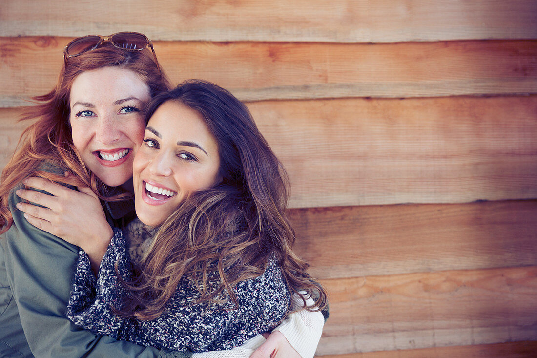 Smiling female friends hugging