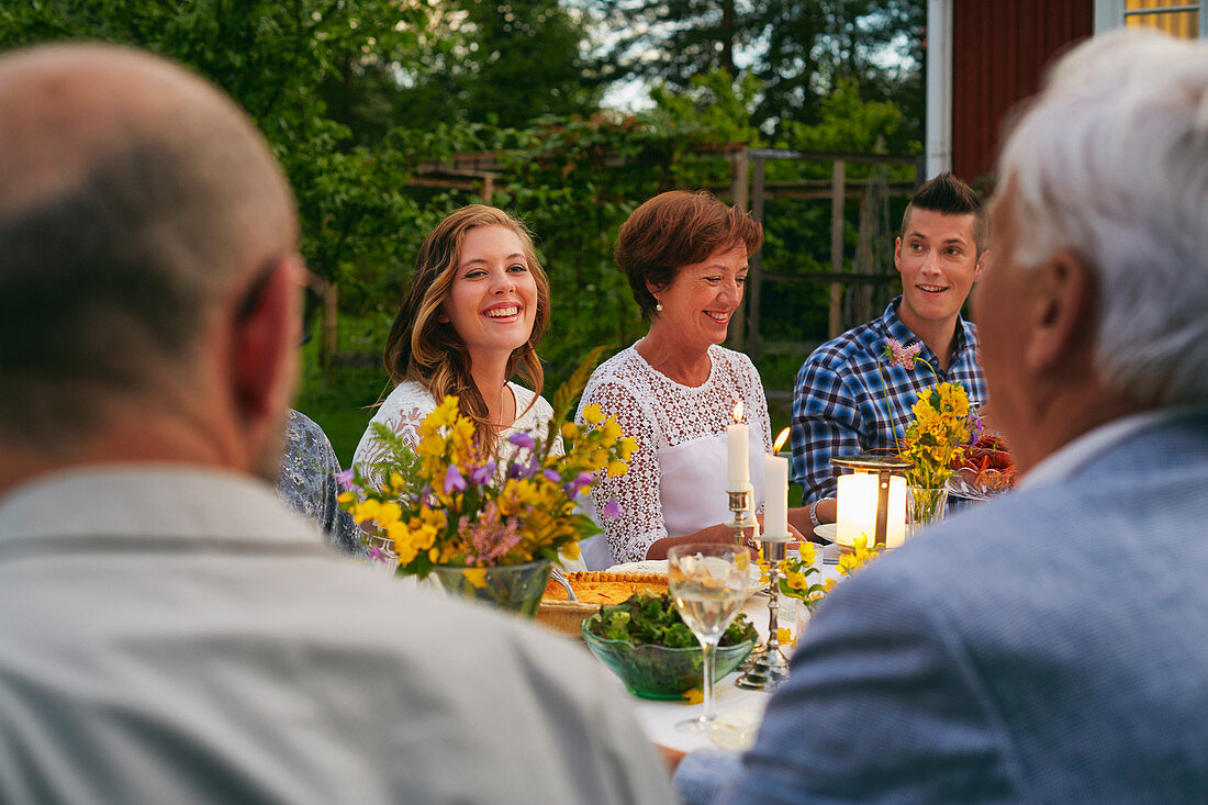 Woman enjoying family garden party dinner