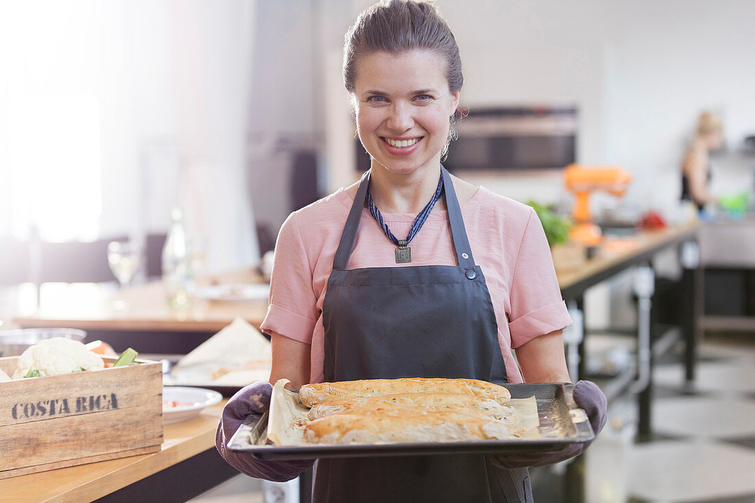 Woman holding tray in cooking class