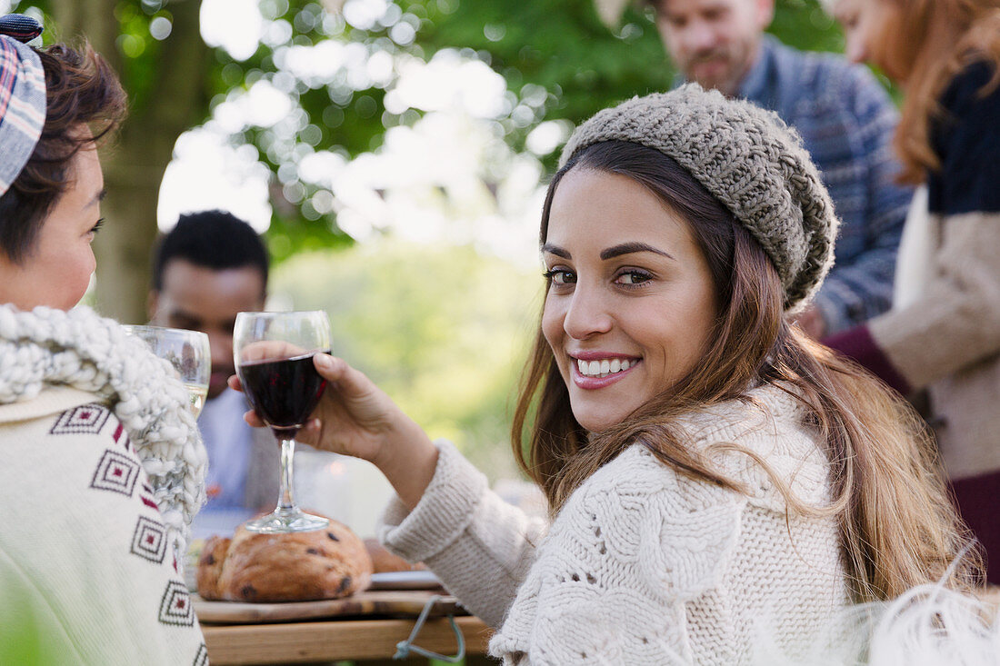 Woman drinking wine with friends