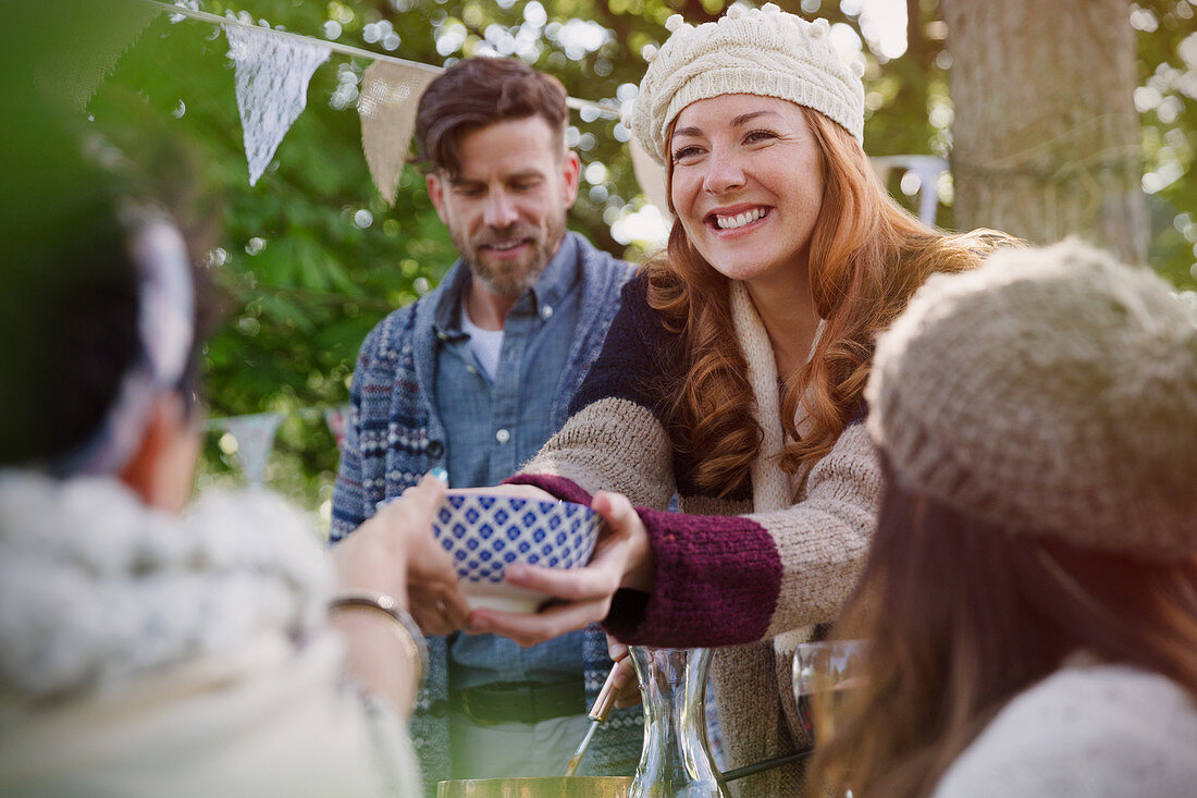 Woman passing food to friend