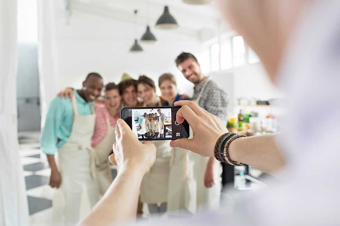 Man photographing cooking class